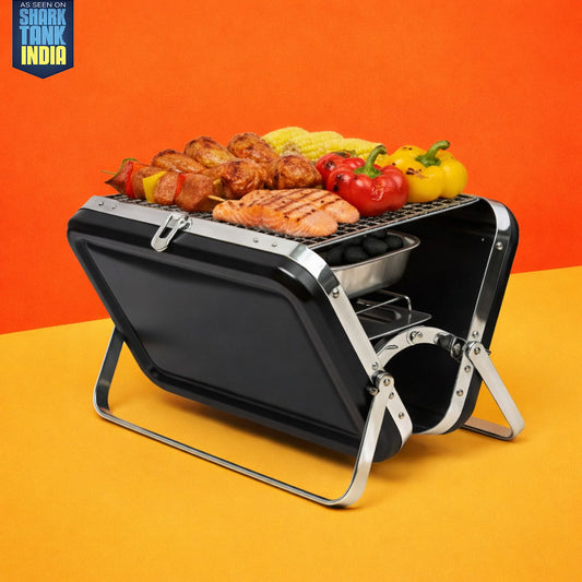 Portable grill with food on an orange and yellow background, featuring the Shark Tank India logo.